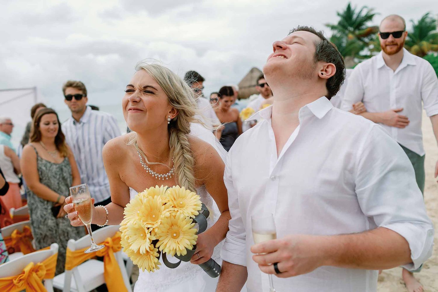 Emotional beach wedding ceremony photographed by a Cancun wedding photographer with tropical Caribbean scenery.