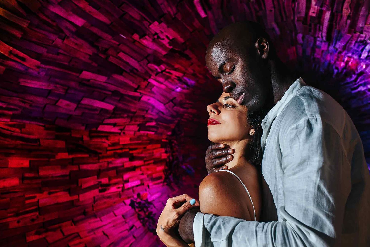 Creative wedding portrait at Hard Rock Riviera Maya with dramatic colorful lighting and artistic destination wedding style.