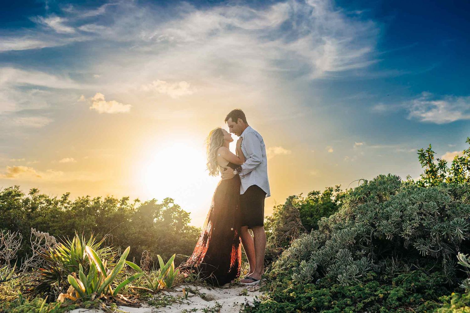 Sunset silhouette of an engaged couple during golden hour in Punta Esmeralda Playa del Carmen.
