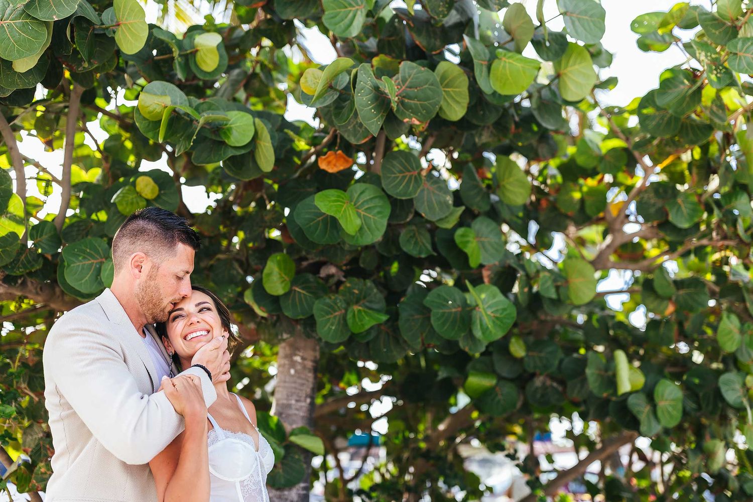 Natural engagement portrait under tropical trees in Puerto Morelos Cancun