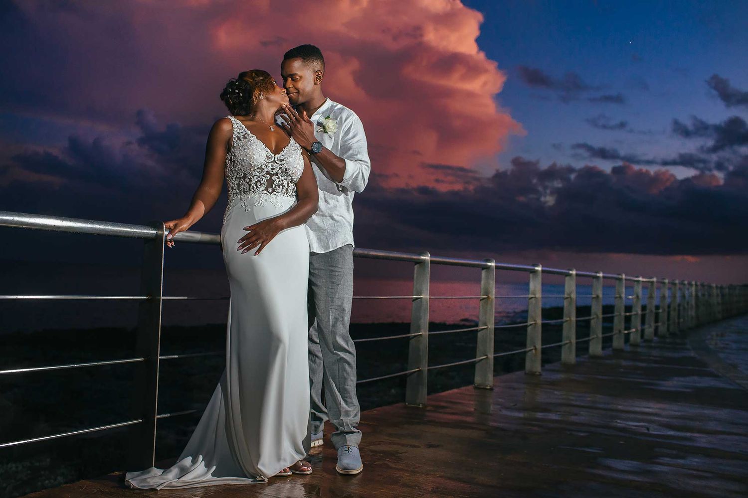 Romantic sunset wedding portrait at Hyatt Ziva Cancun with dramatic Caribbean sky and elegant destination wedding style.