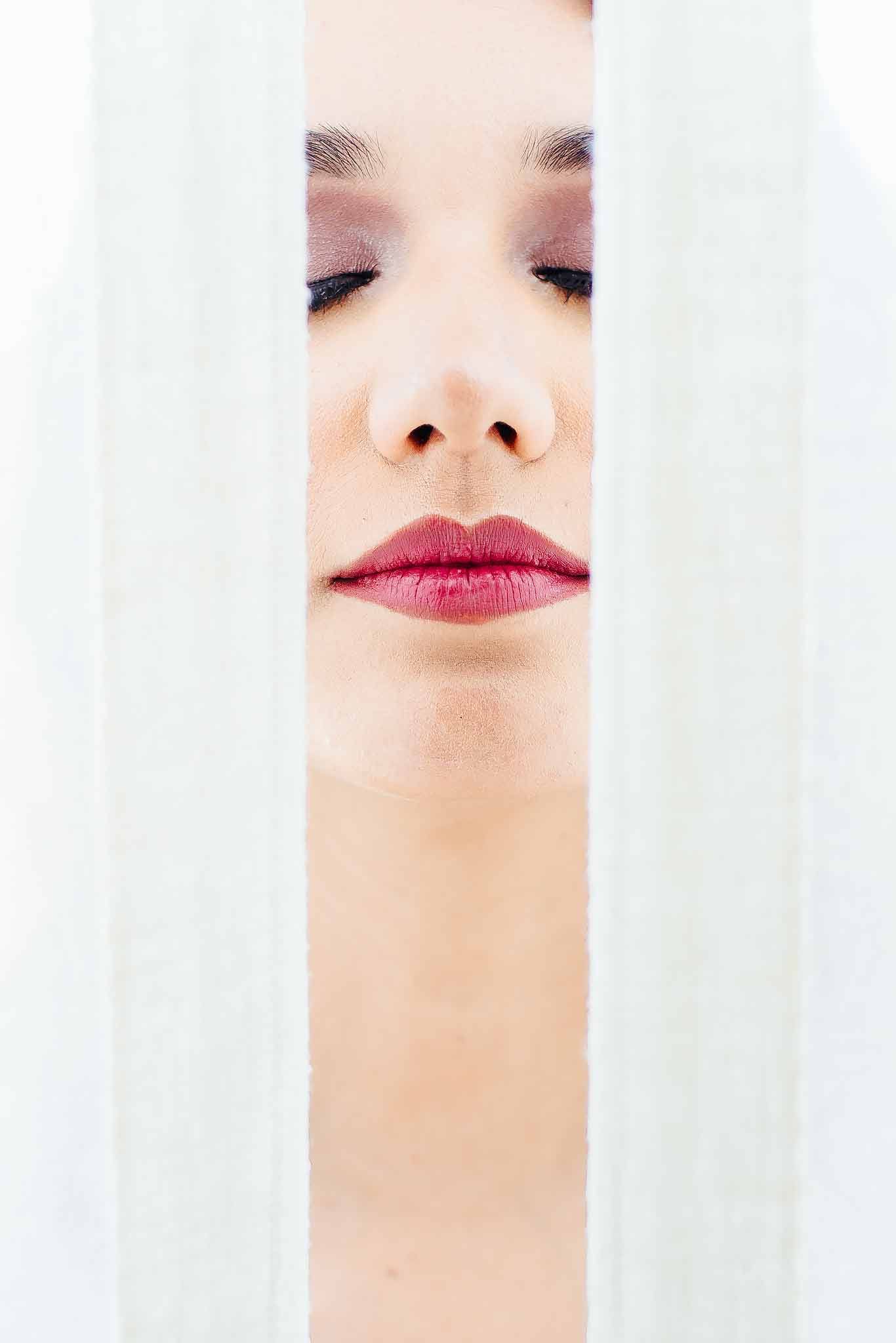 Close-up bridal portrait with soft makeup behind veil during getting ready in Playa del Carmen, destination wedding photography