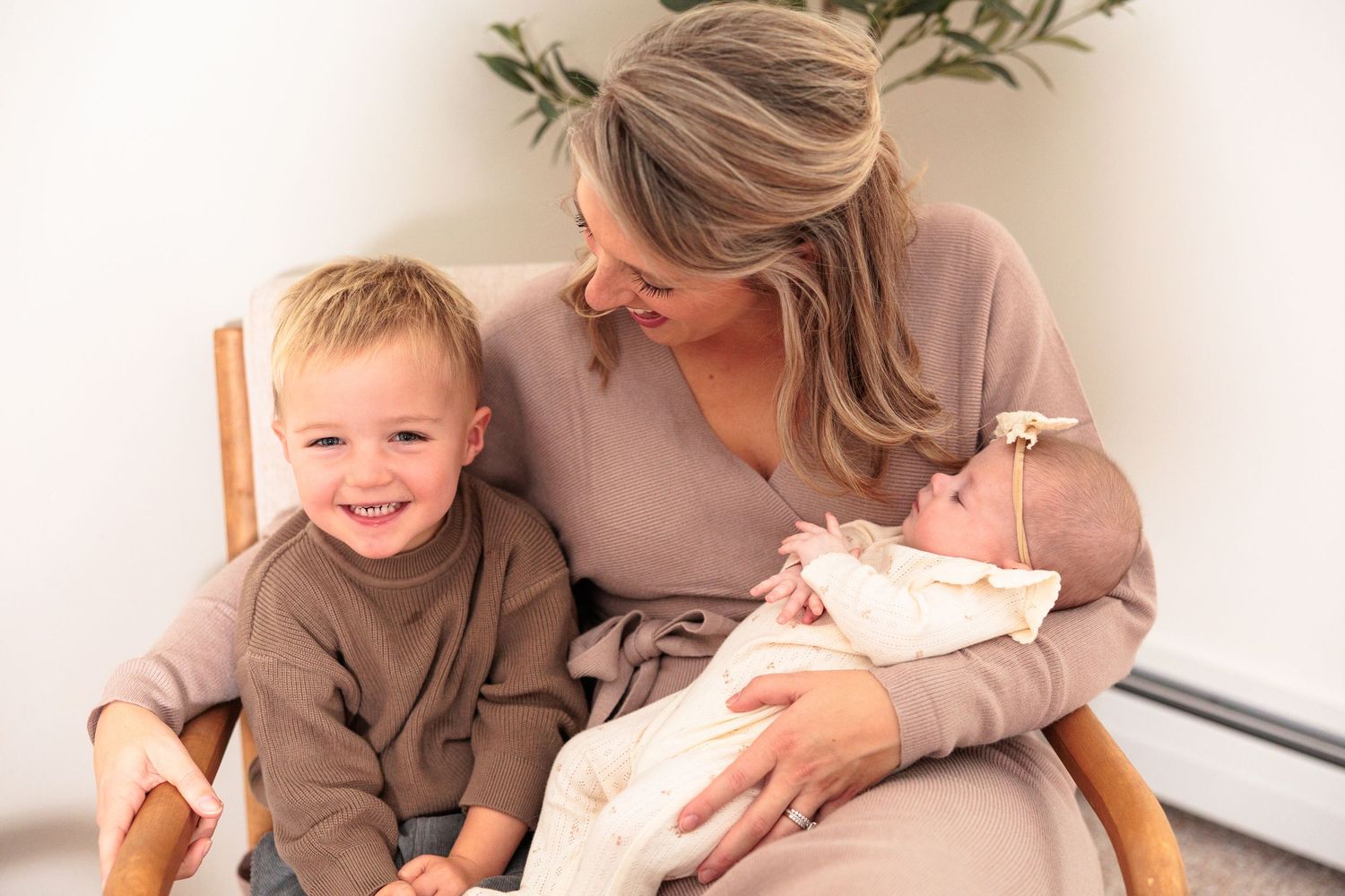Family lifestyle photography session showing warm interactions in a bright white setting.