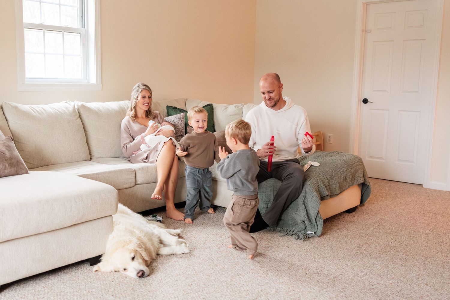 A sequence of photos showing a family lounging and playing together in a bright, modern living room.