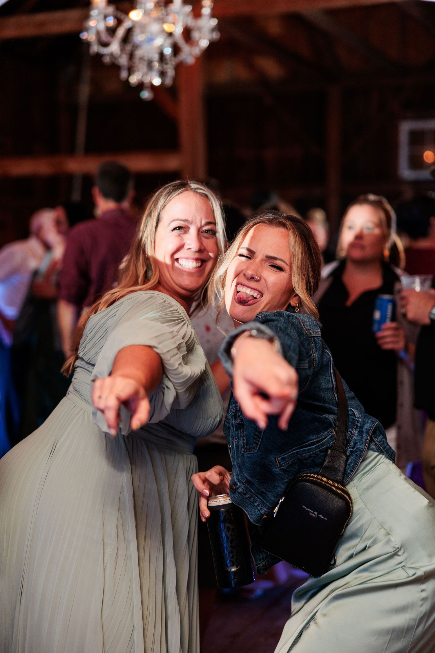 Guests enjoying themselves on the dance floor at a rustic barn wedding reception.