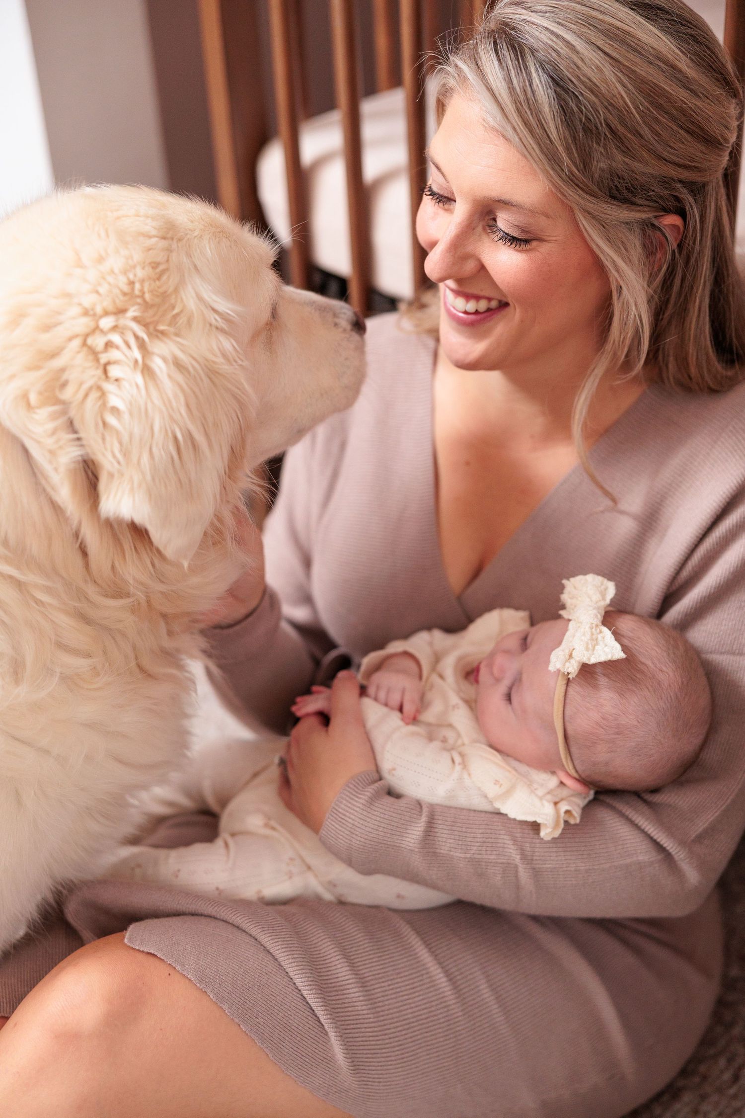A heartwarming series of photos showing tender moments between a parent and baby with a white dog.