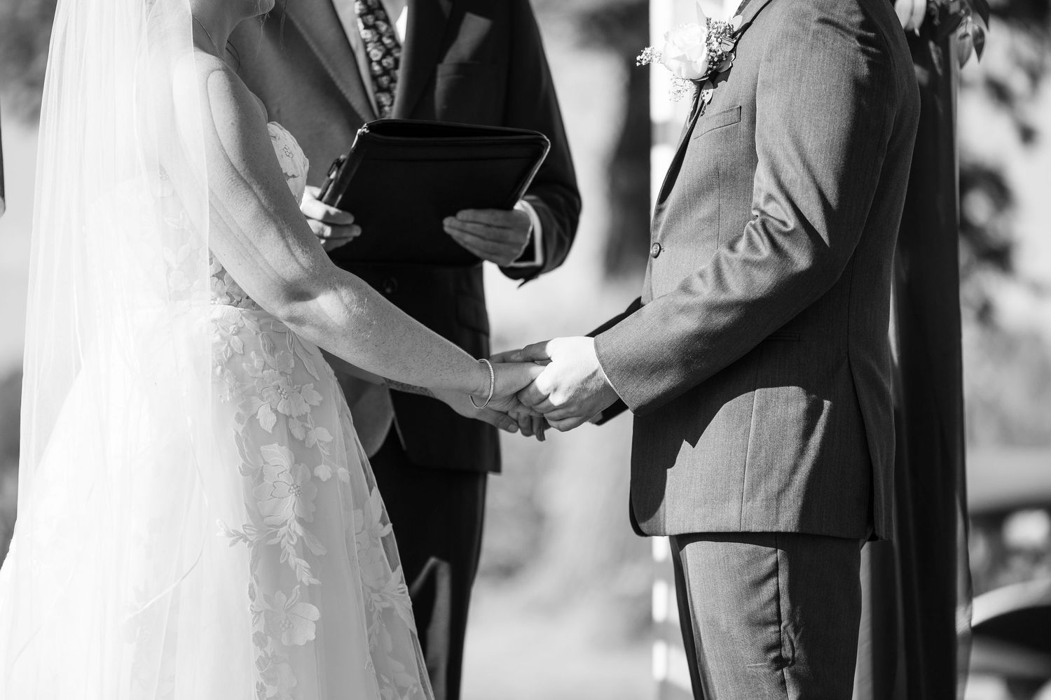 Black and white wedding photos showing tender moments during the ceremony.