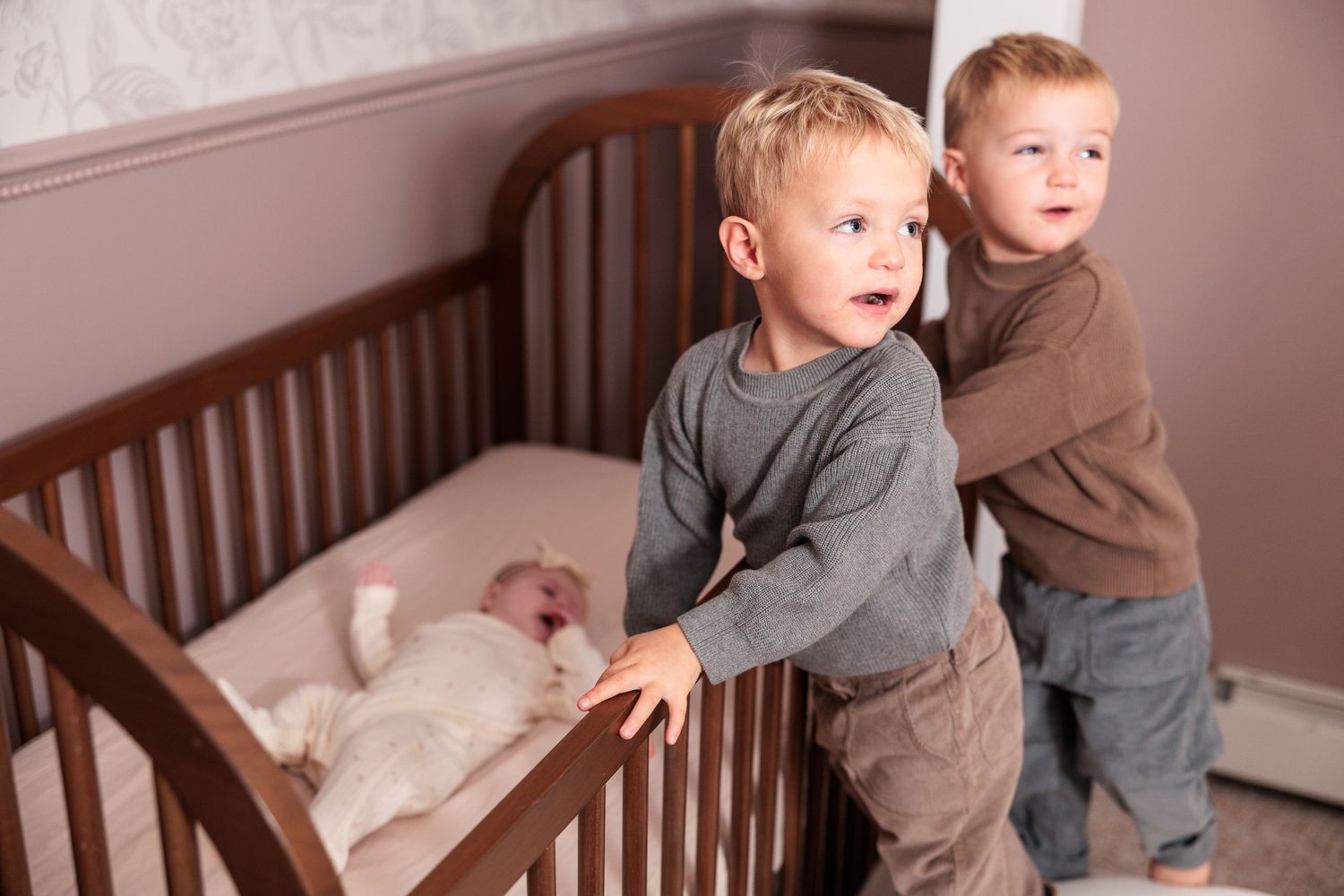 A sequence of photos showing a child climbing up onto a window ledge from a crib.