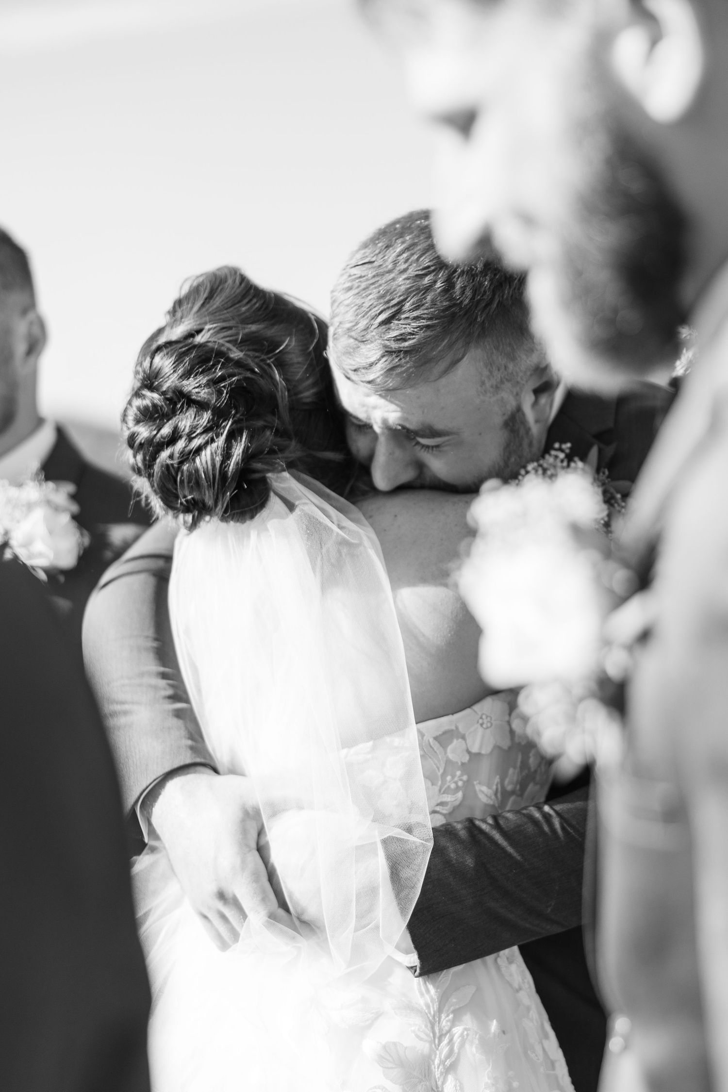 A black and white wedding photo montage shows tender moments between a couple during their special day.