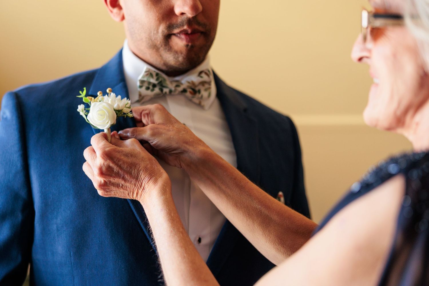 Wedding preparation scene with formal attire in warm lighting.