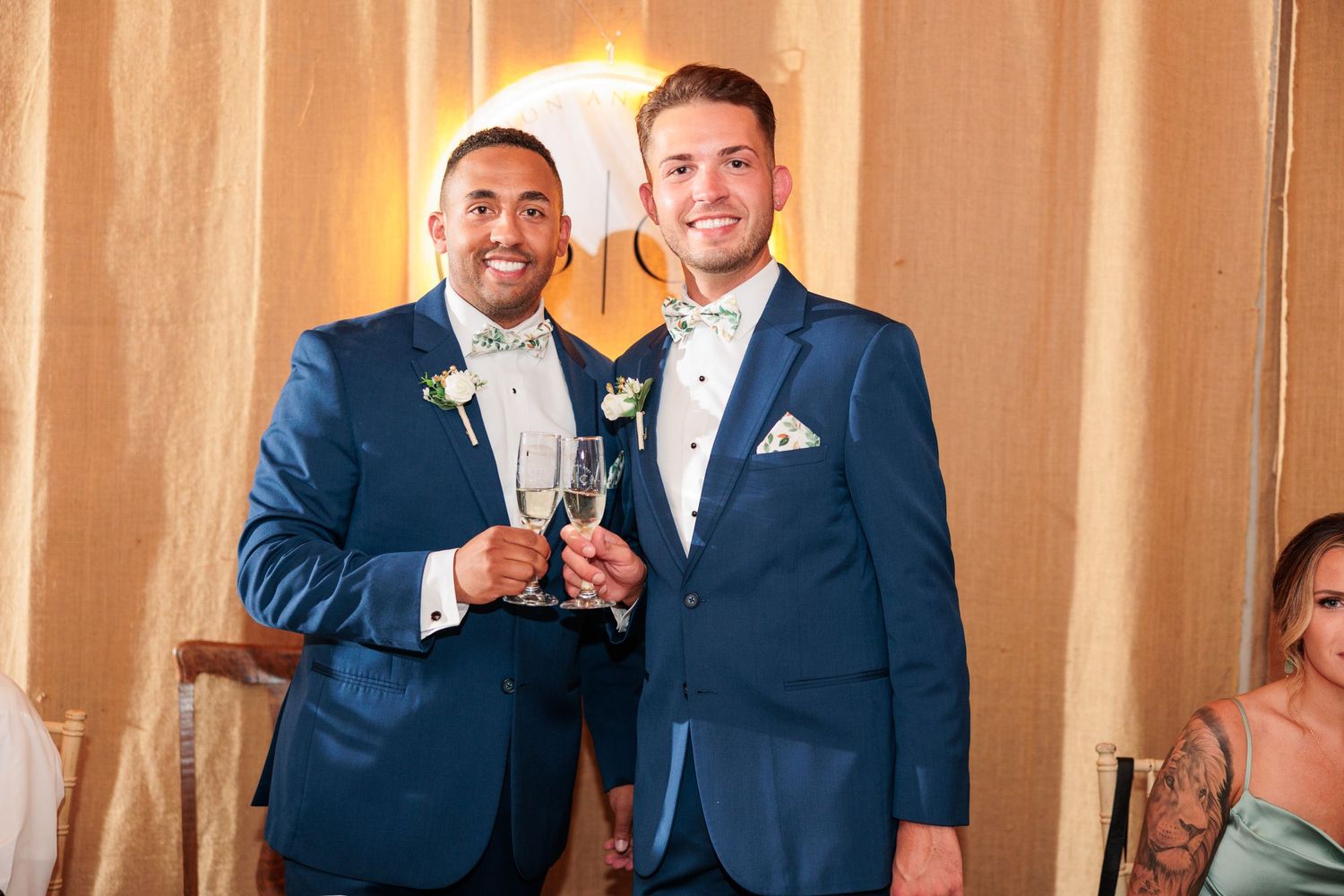 Wedding celebration inside barn venue with warm ambient lighting and formal attire.