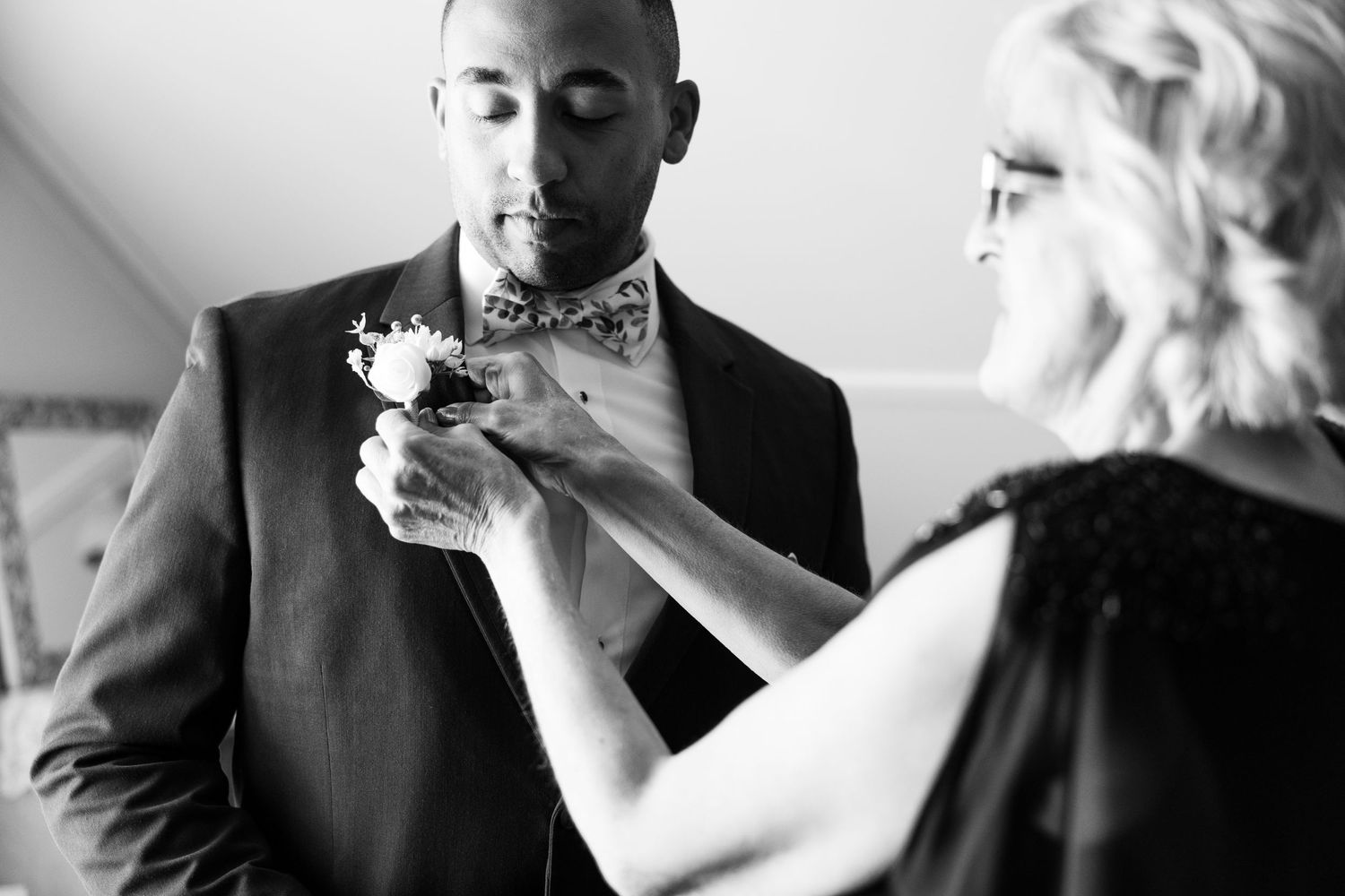 Intimate black and white wedding moment between couple.