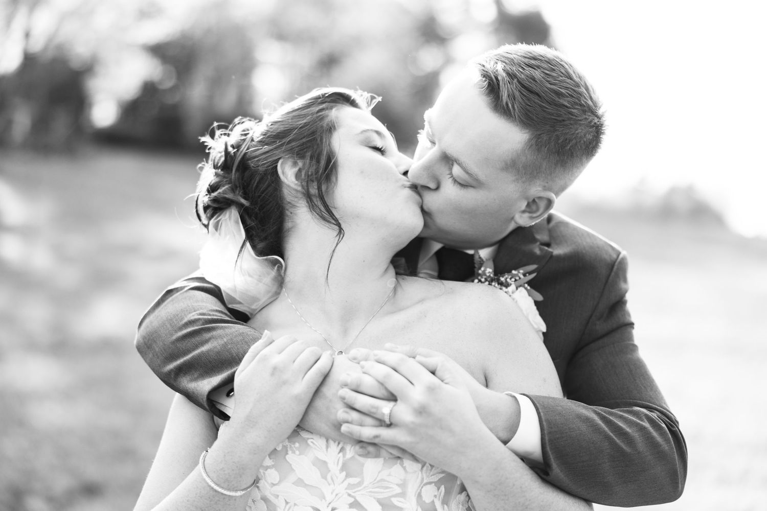 Black and white romantic wedding portrait capturing intimate moment between newlyweds.