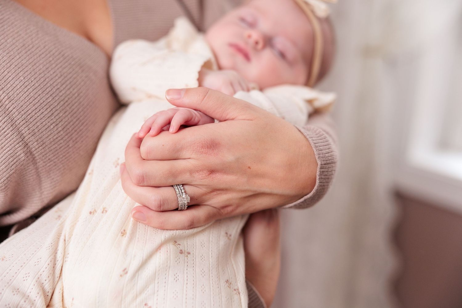 Close-up of hands embracing during an intimate dance moment in a sunlit room.