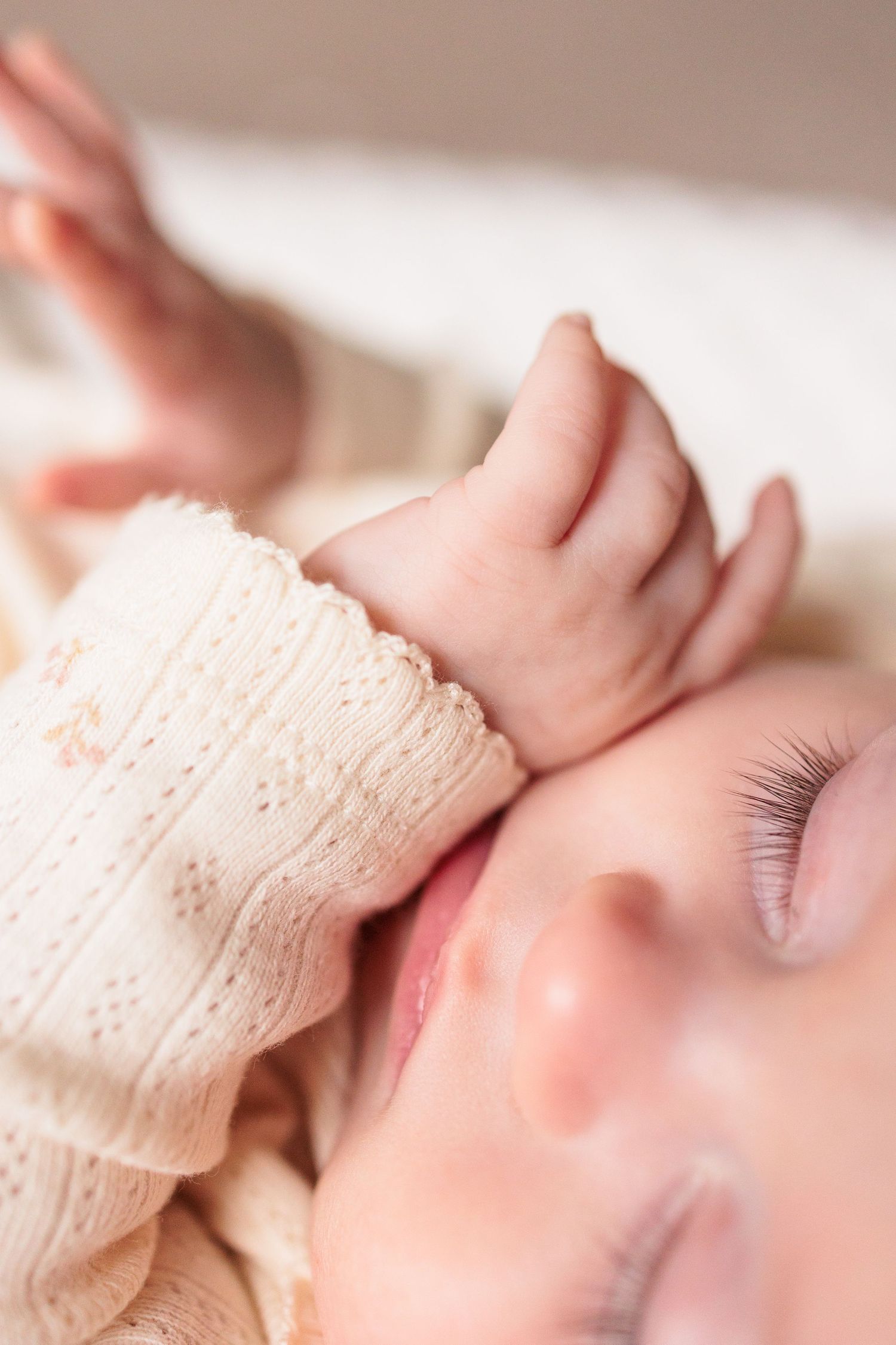 Close-up macro shots of eyelashes in soft, warm lighting with delicate lace fabric.