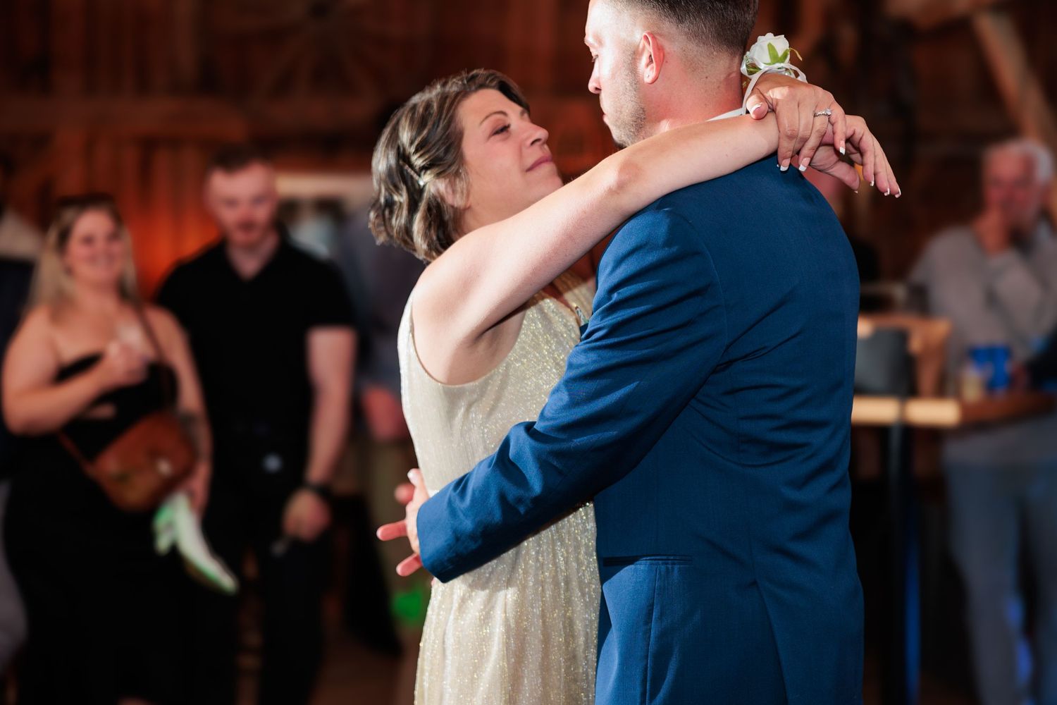 Couples share romantic dances in a warmly lit rustic venue.