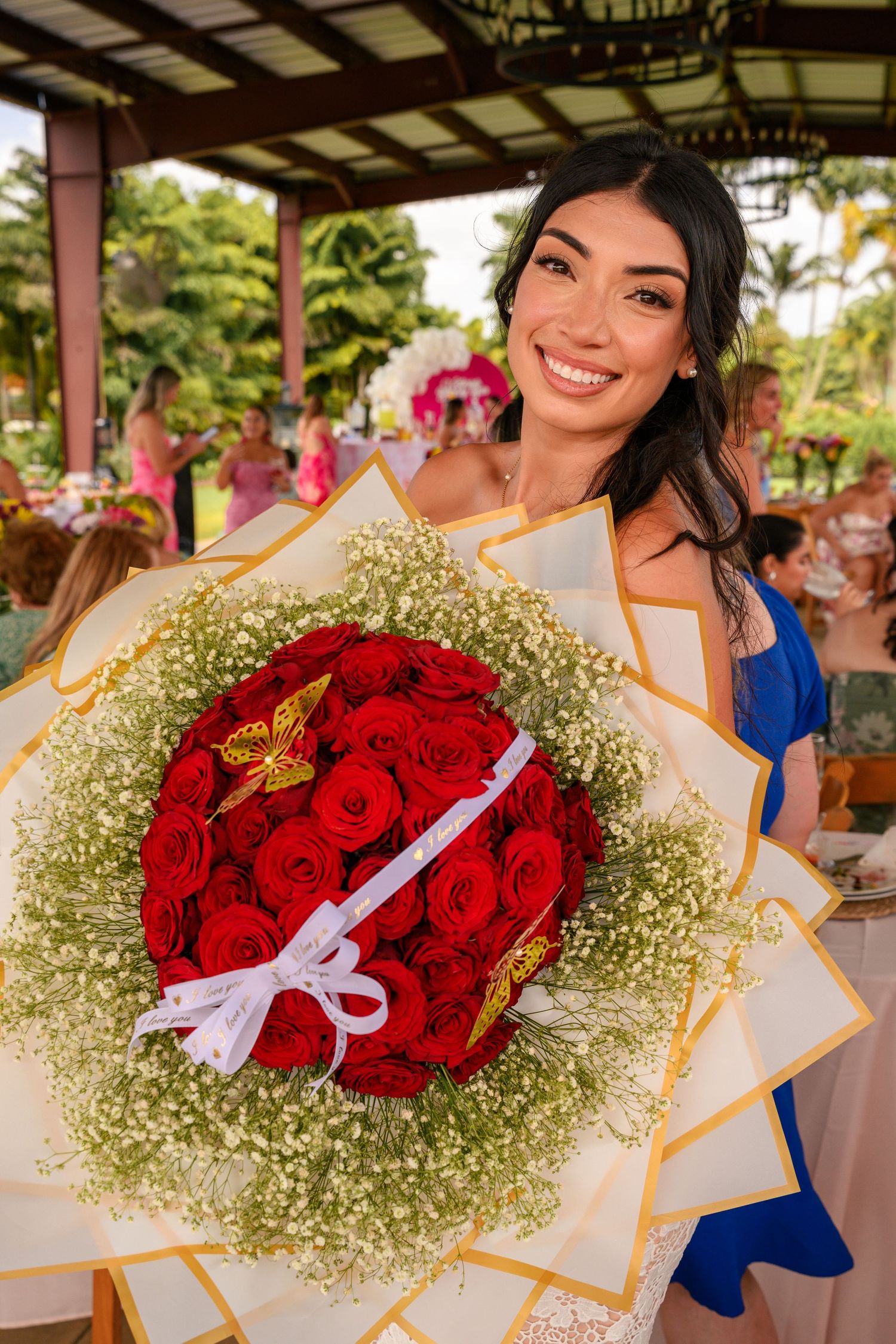 A vibrant bouquet featuring red roses surrounded by delicate baby's breath flowers in a romantic arrangement.