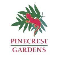 Pinecrest Gardens logo featuring a red gecko on a green tropical leaf branch.
