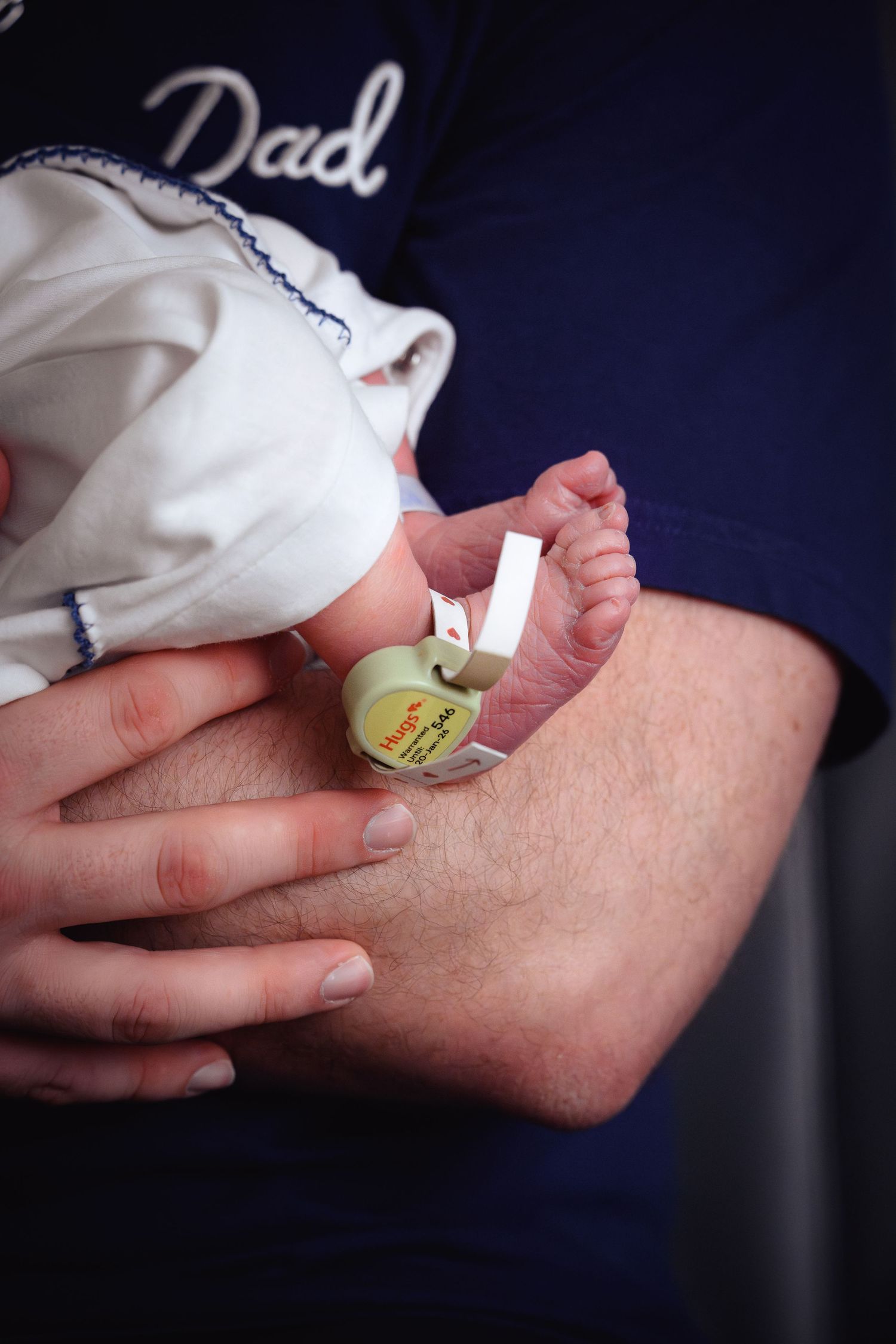 Close-up sequence showing hands removing protective backing from a medical sensor or monitoring device.