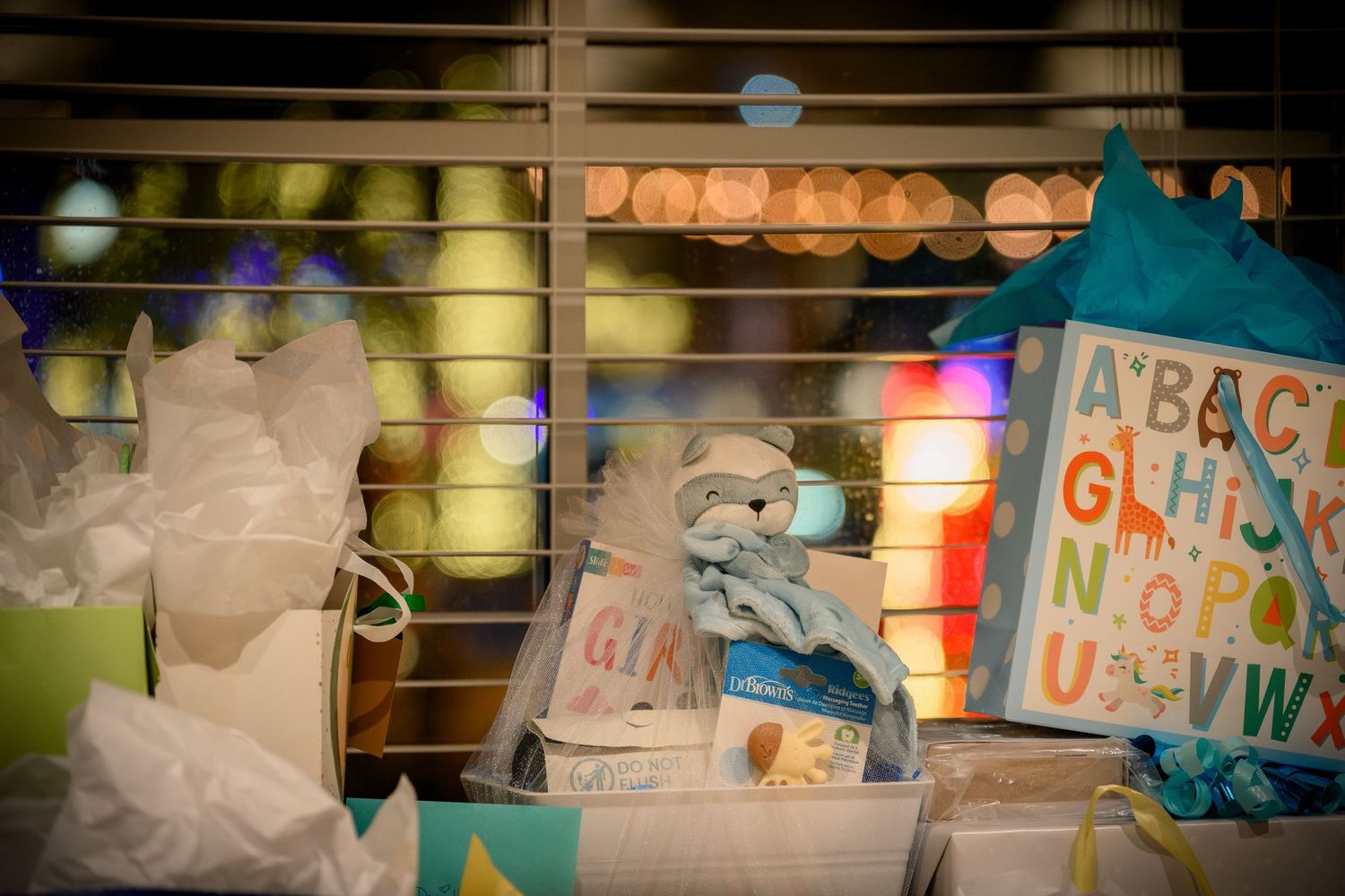 A collection of colorful educational alphabet letters and toys arranged on wooden shelves in a classroom setting.