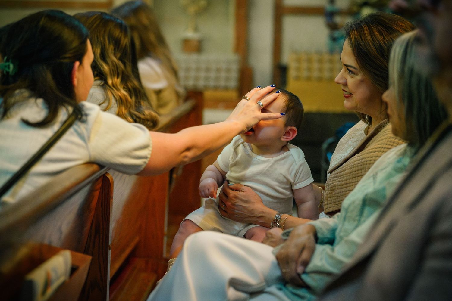 A candid moment at Catholic baptism at St. Raymond, Coral Gables, Miami FL