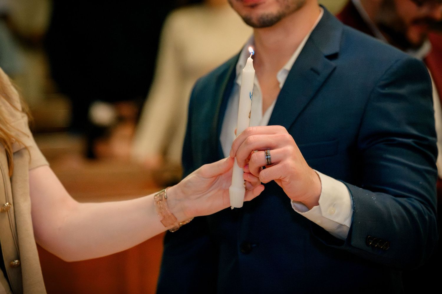 A couple in formal attire toasts with champagne glasses during an elegant celebration.