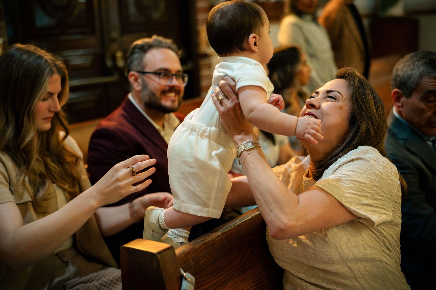 A candid moment before the ceremony of a Catholic baptism at St. Raymond, Coral Gables, Miami FL