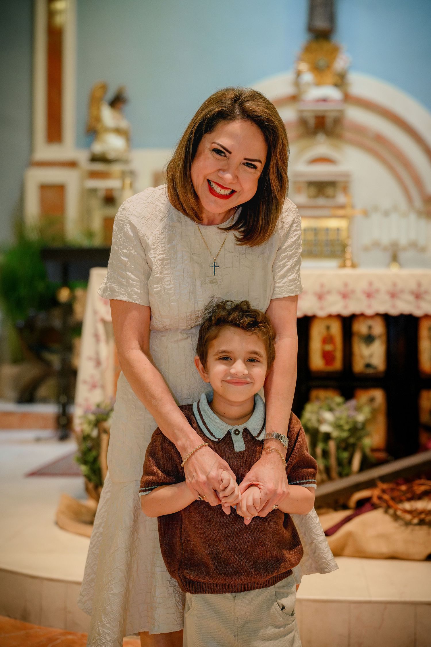 A series of warm-toned photos showing tender moments between parent and child in a church or religious setting.