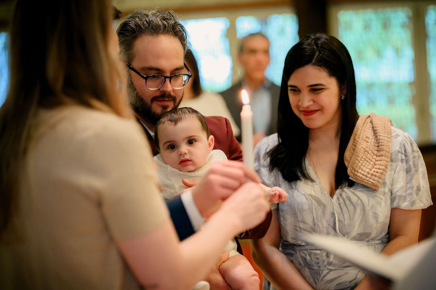 A series of candid photos showing tender family moments at a gathering with a baby and loved ones.