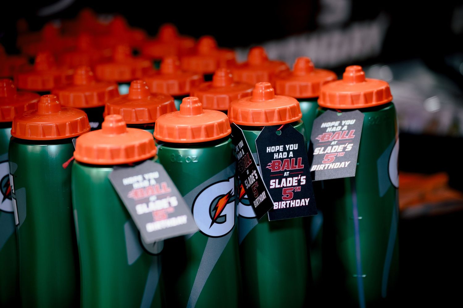 Green Gatorade water bottles with orange caps and birthday party tags for Slade's birthday celebration.