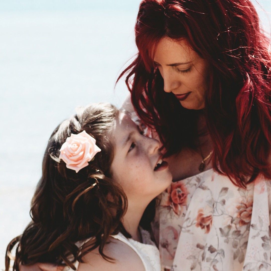 Mother and daughter sharing a moment, warm natural light family photography