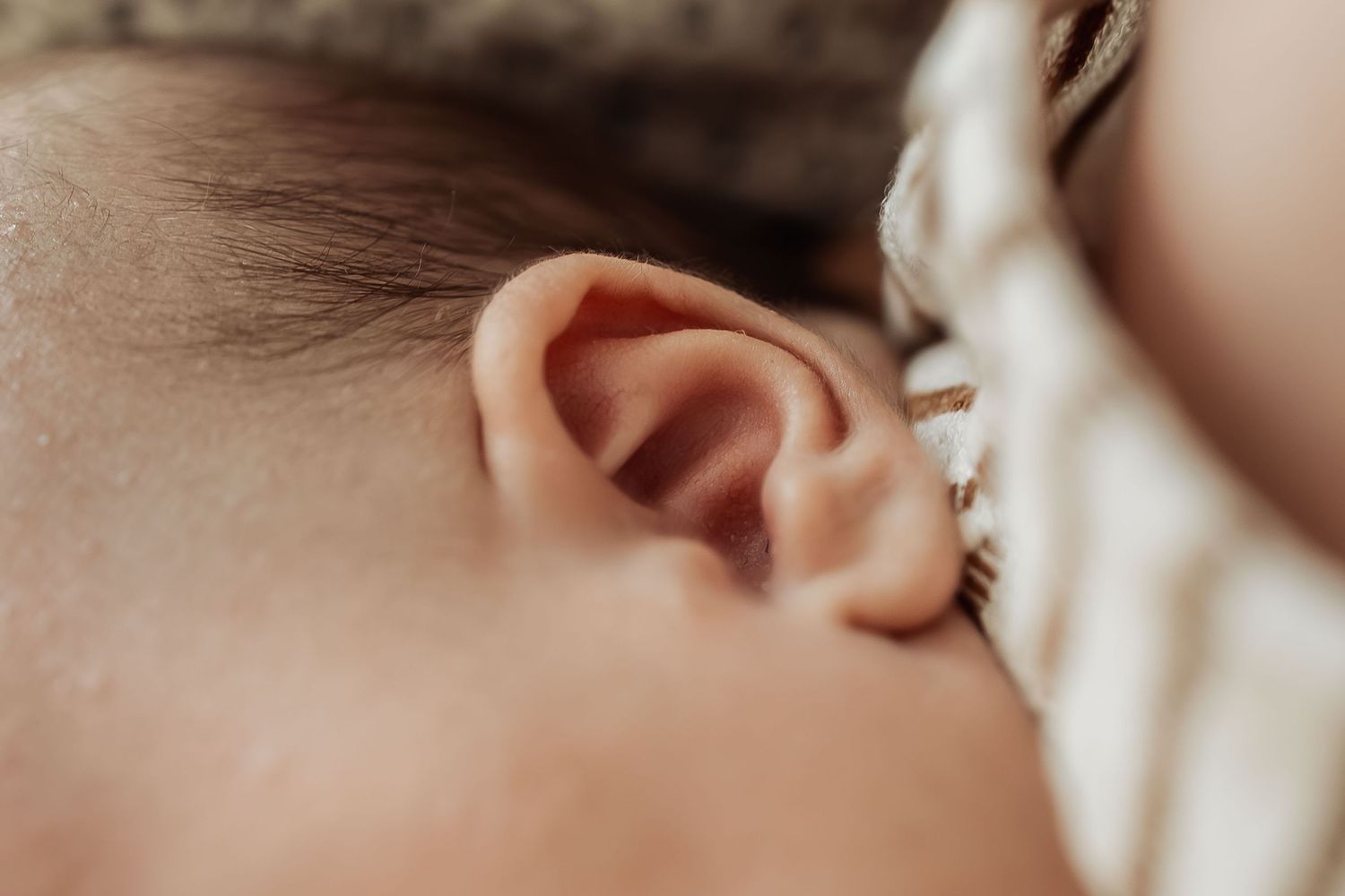 Newborn detail photography Adelaide — close-up of newborn during an in-home lifestyle session, photographed by Photo by Nancy