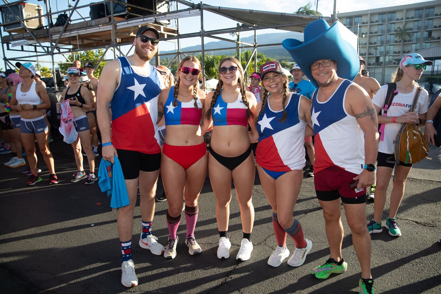 Group of five athletes wearing matching Texas flag-themed outfits posing together the Kona Underpants Run.