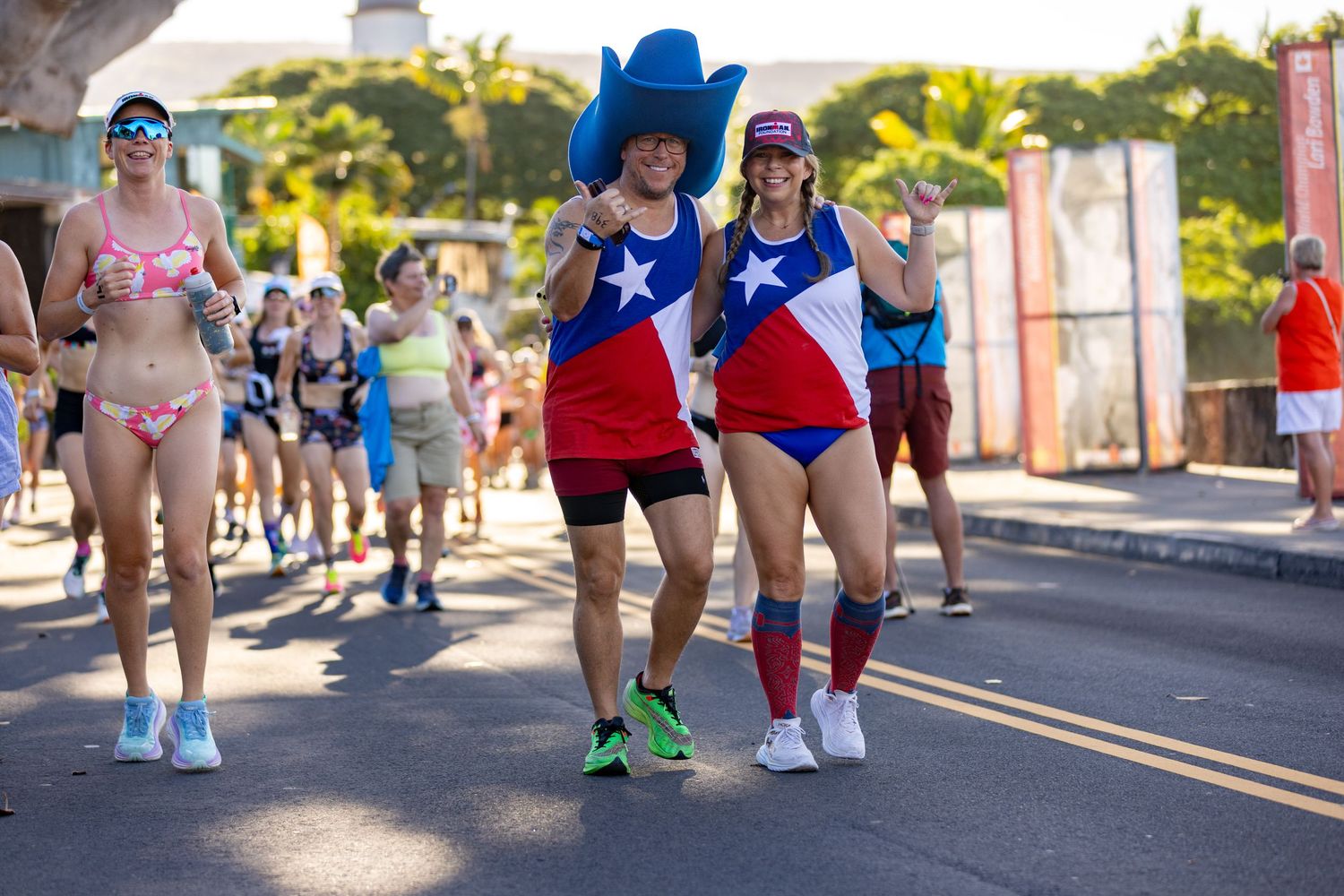 Two participants wearing Texas flag outfits and cowboy hat at the Kona Underpants Run in Hawaii.
