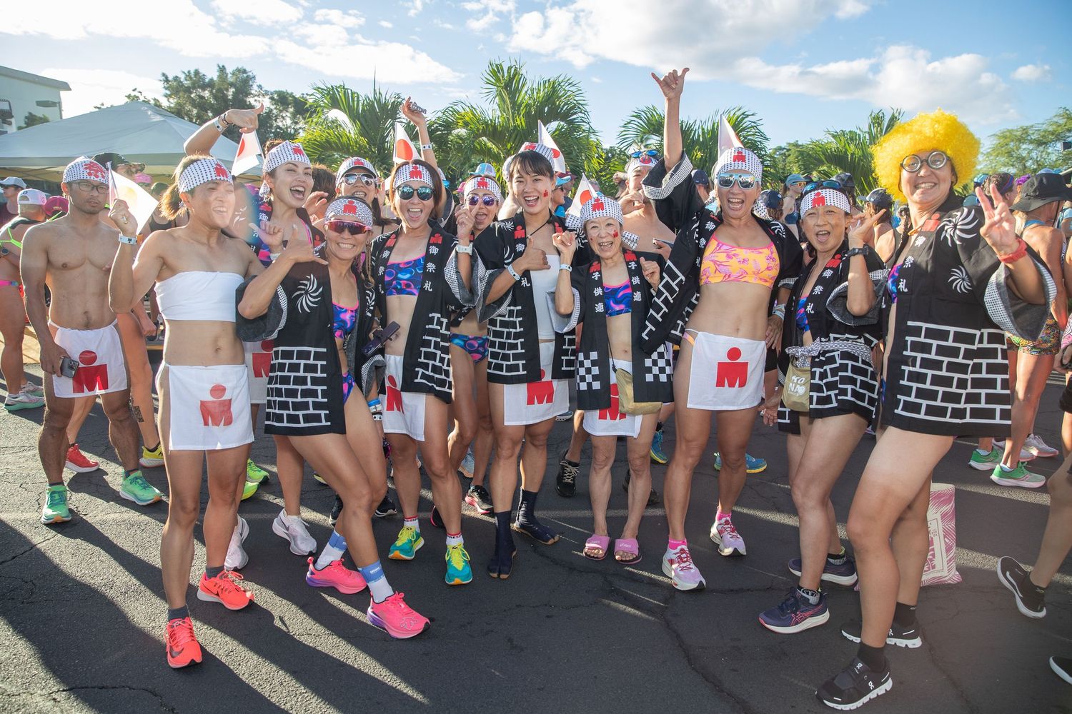 Group of runners in festive costumes with paper hats at the Kona Underpants Run.