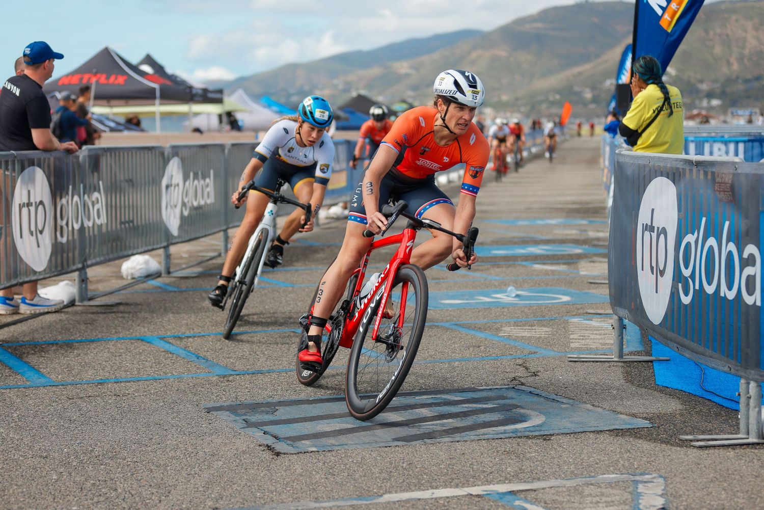 Cyclists racing in the Malibu Super League Tri event, with competitors in colorful jerseys.