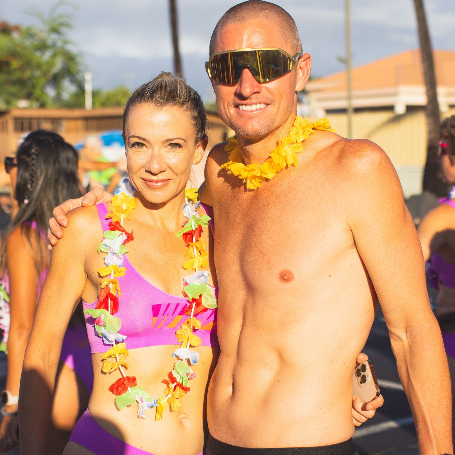 Man and woman wearing colorful leis and athletic wear smiling at the Kona Underpants Run.