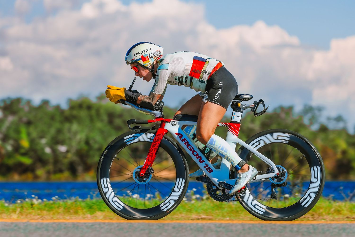 Heather Jackson in aerodynamic position rides a time trial bike along the IRONMAN Florida course.