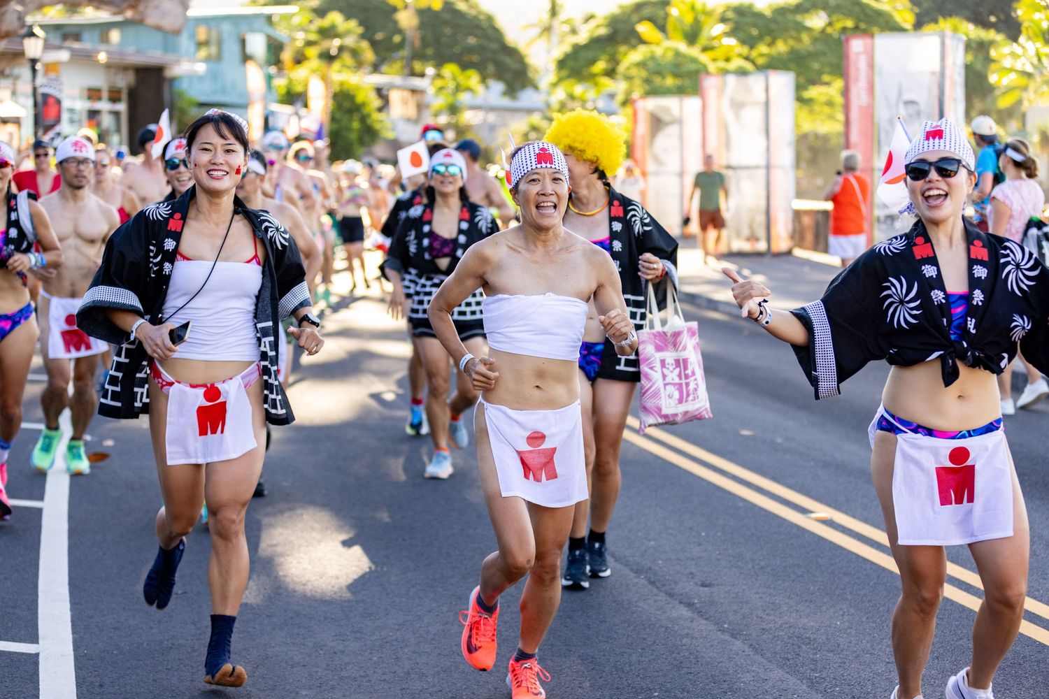 Runners in traditional Japanese happi coats with Ironman logos jogging during the Kona Underpants Run.