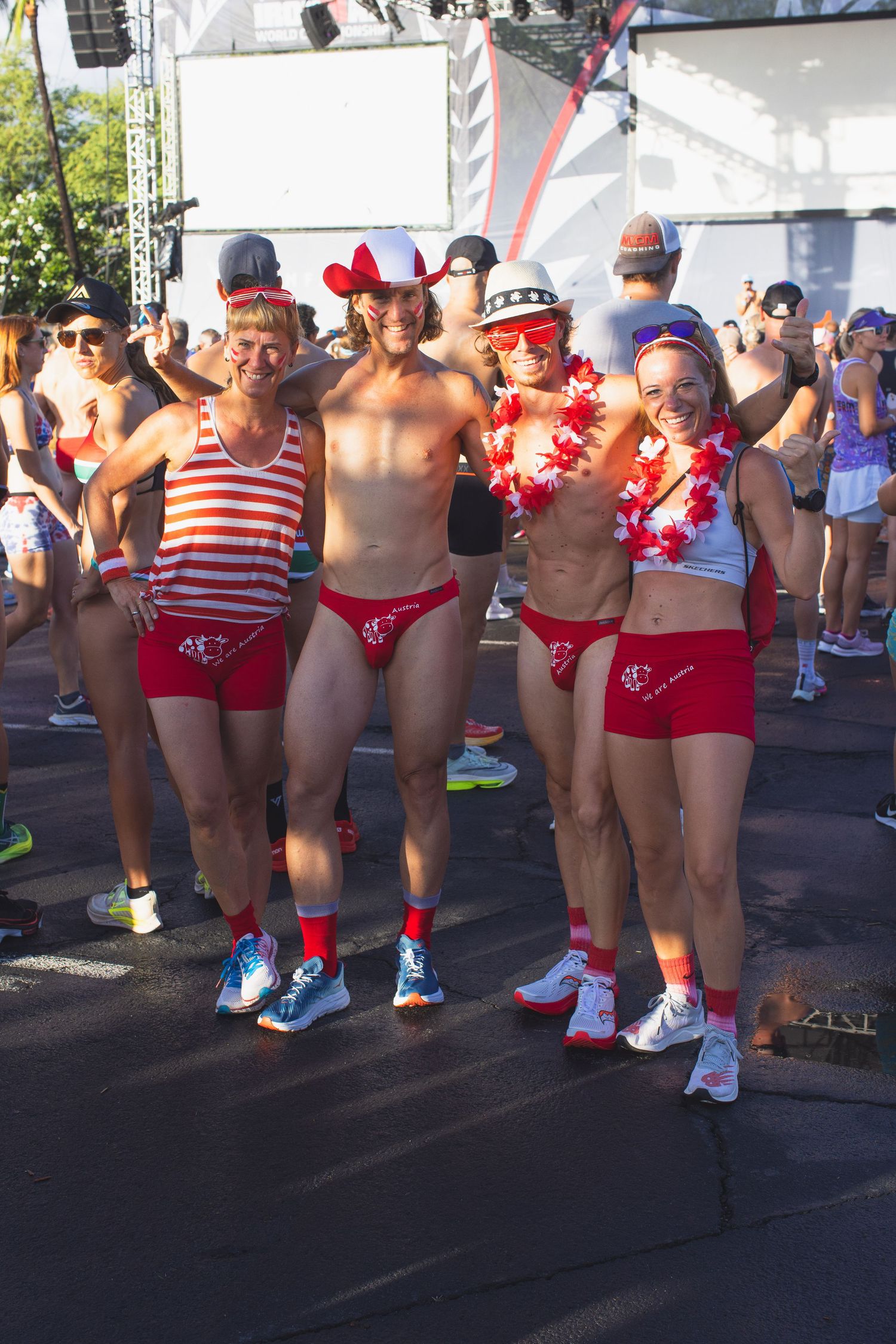 Four athletes in matching red and white outfits posing together at the Kona Underpants Run.