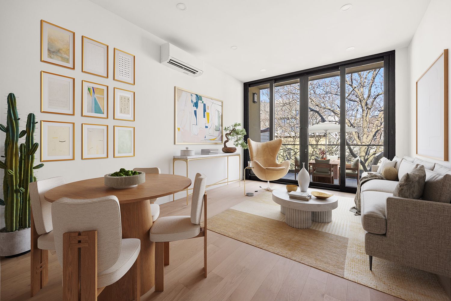 Modern living and dining area with floor-to-ceiling windows, natural wood furniture, neutral tones, and a mini-split AC unit.