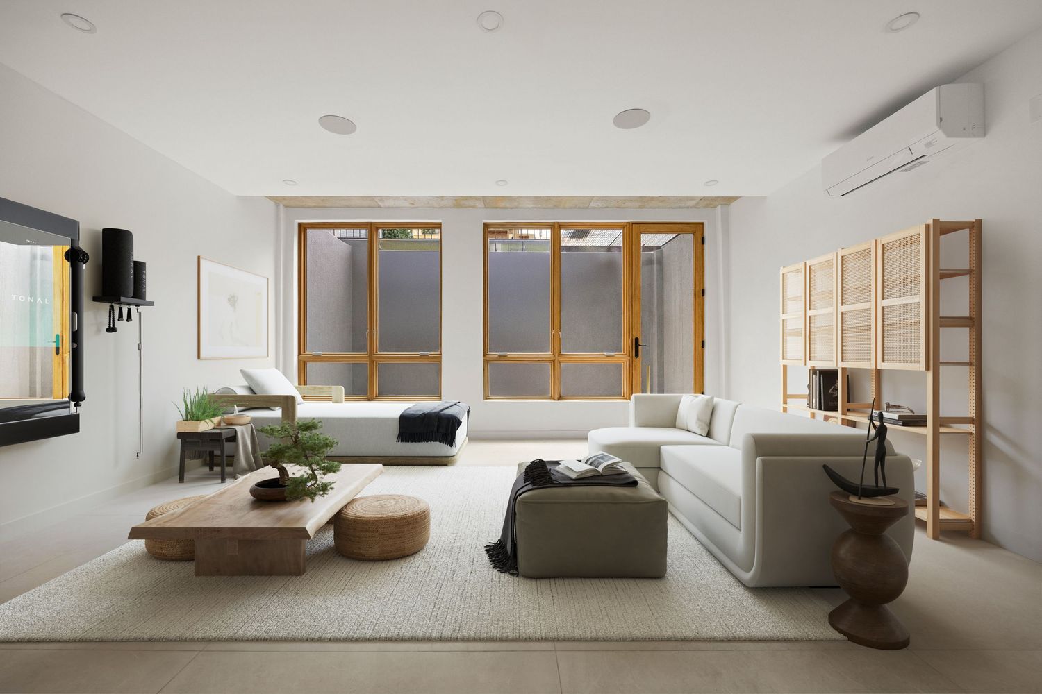 Modern minimalist basement with white sectional sofa, wooden coffee table, large windows, and open shelving in neutral tones.