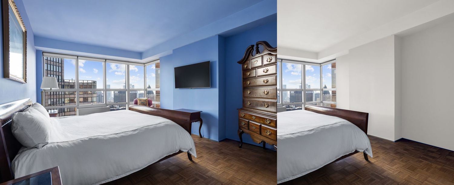 Modern bedroom with blue accent wall, city views, hardwood floors, white bedding, wall-mounted TV, and antique wooden dresser.