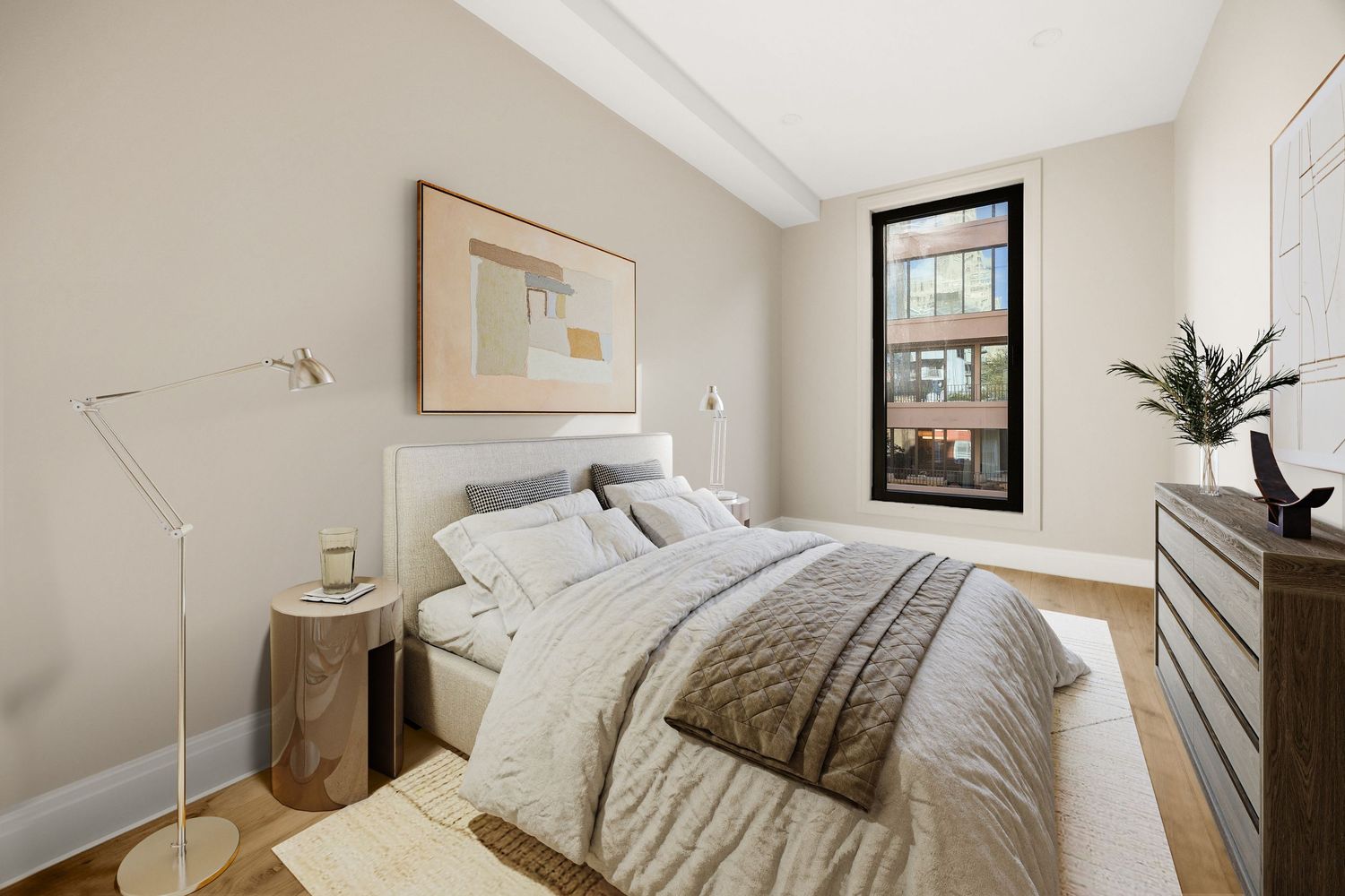 Modern bedroom with beige walls, upholstered bed, wood nightstand, floor lamp, and large black-framed window with natural light.