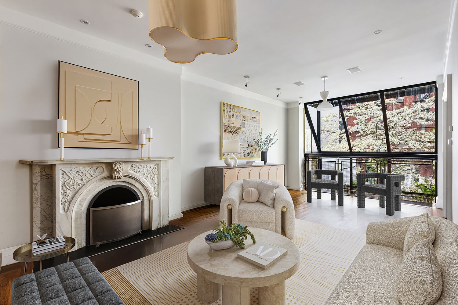 Elegant living room with ornate marble fireplace, neutral furnishings, round coffee table, and floor-to-ceiling windows.