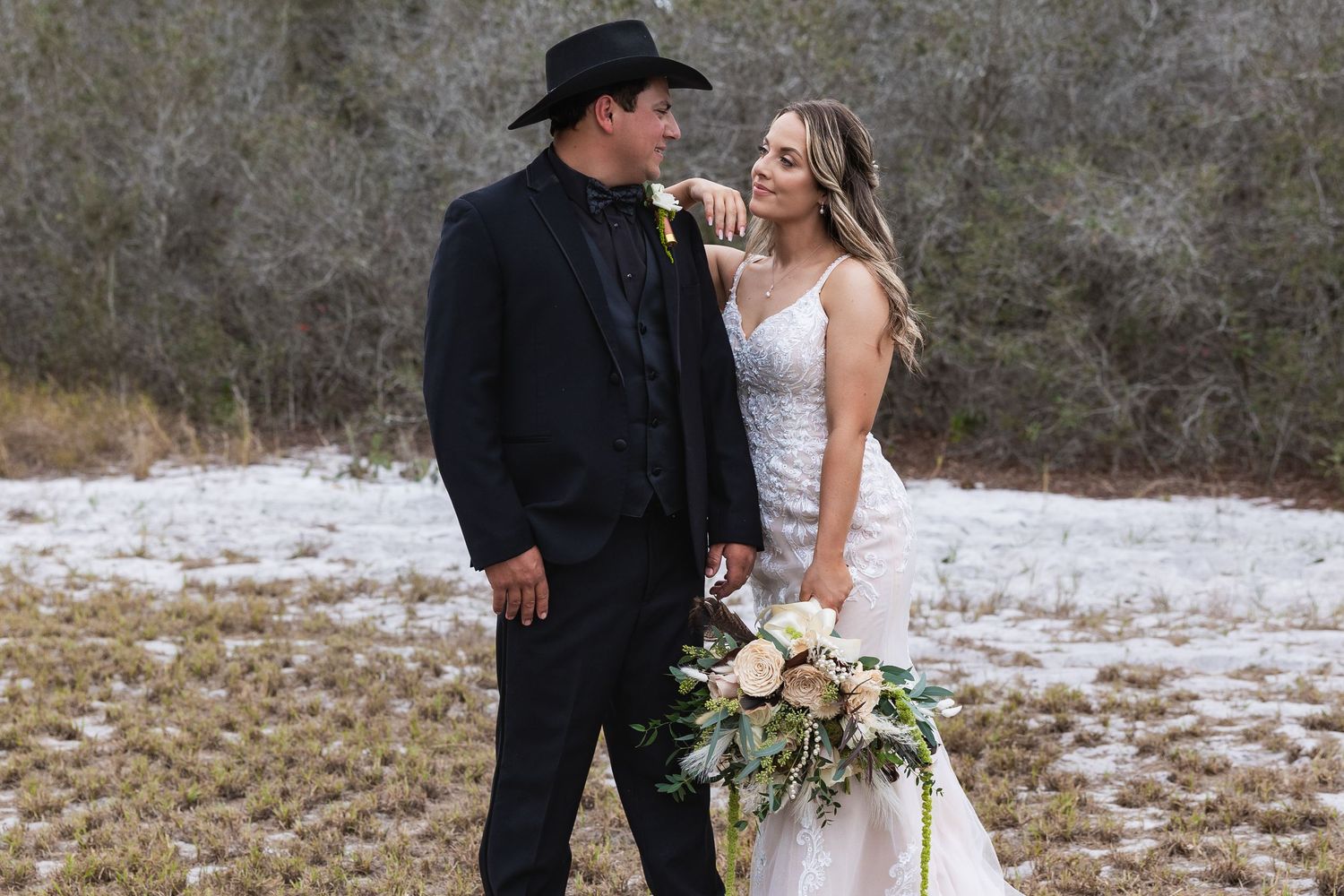 Bride and groom sharing a romantic moment in a snowy winter outdoor wedding setting.