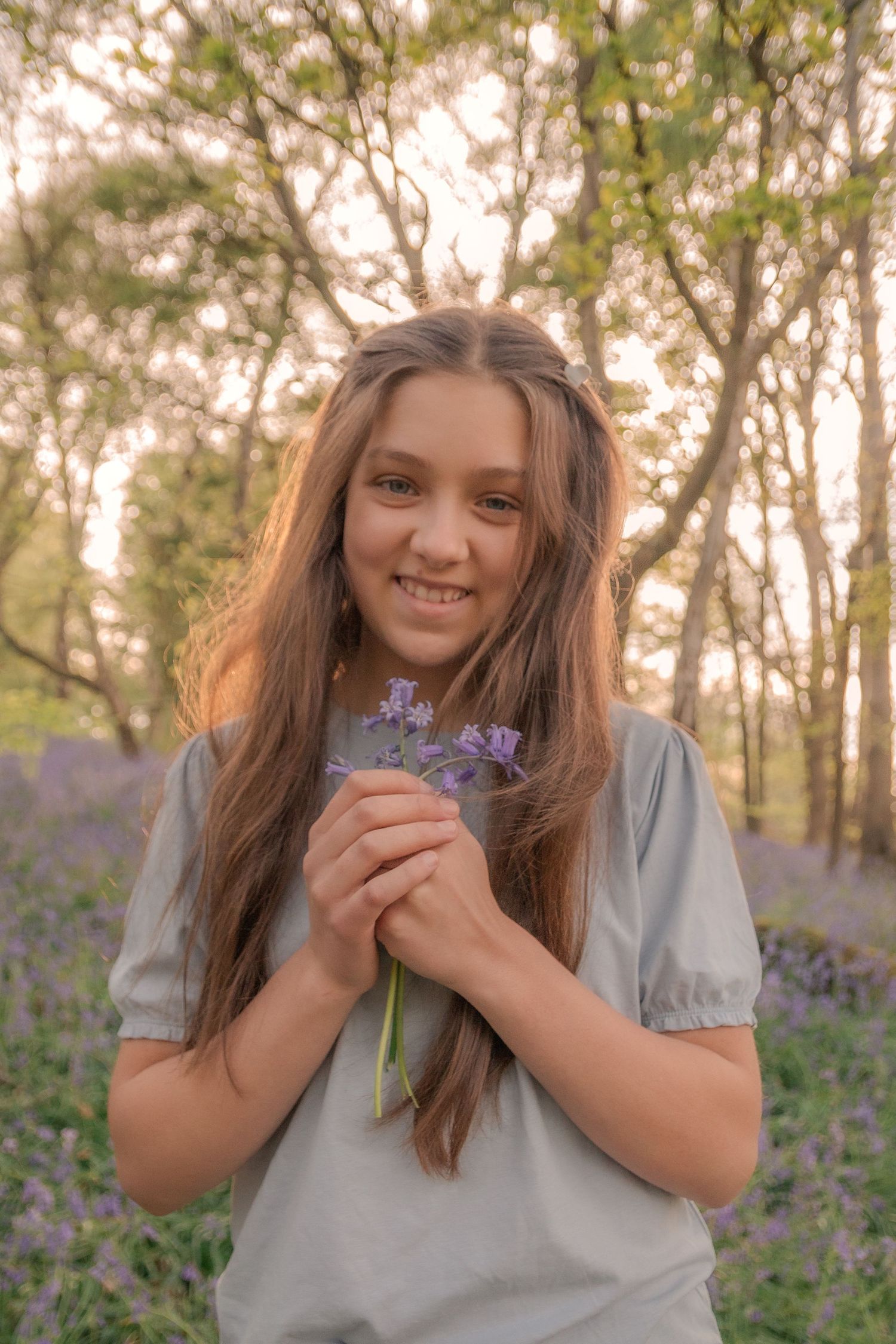 Young girl holding flowers.