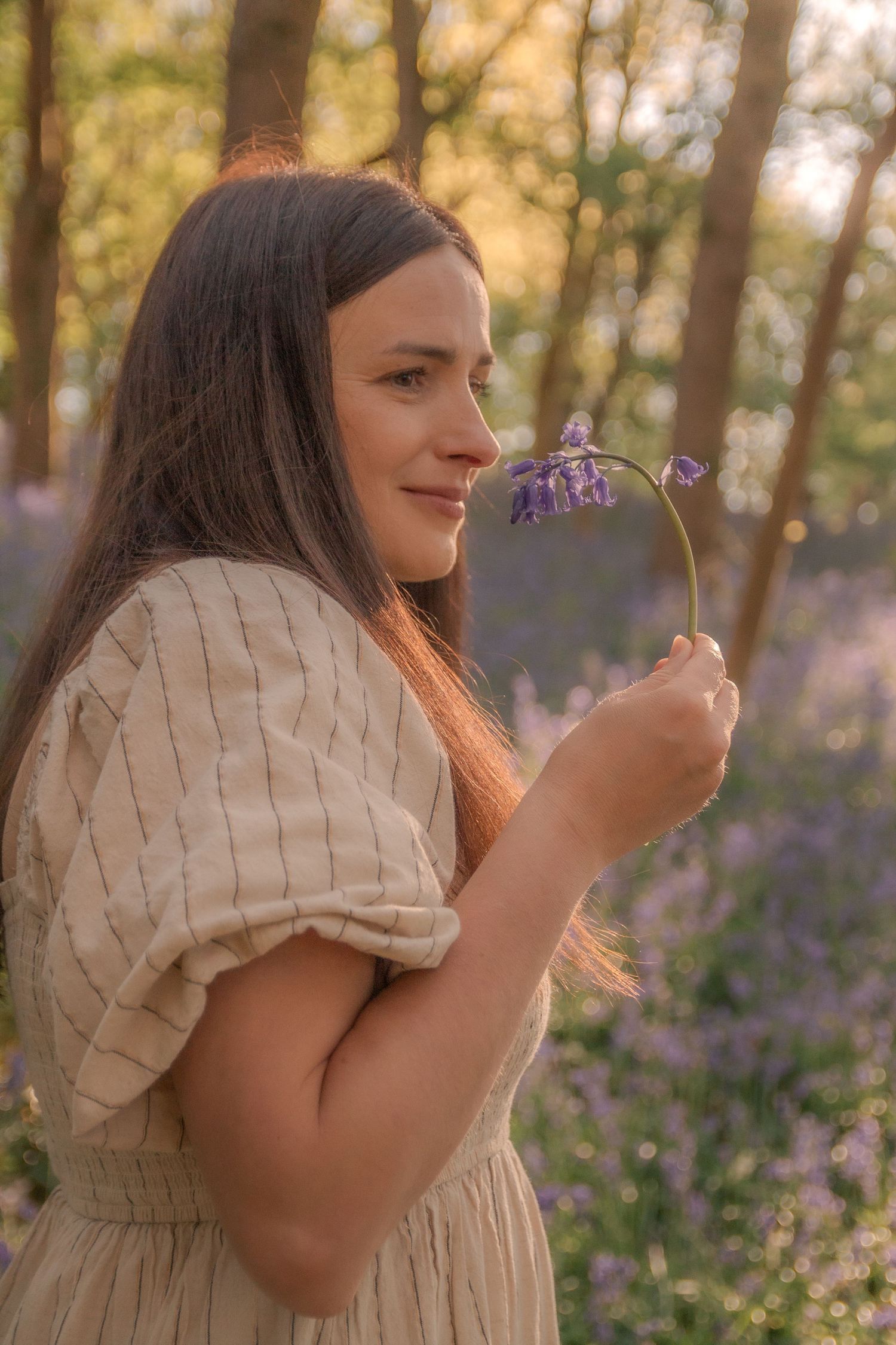 Woman in forest of Bluebells.