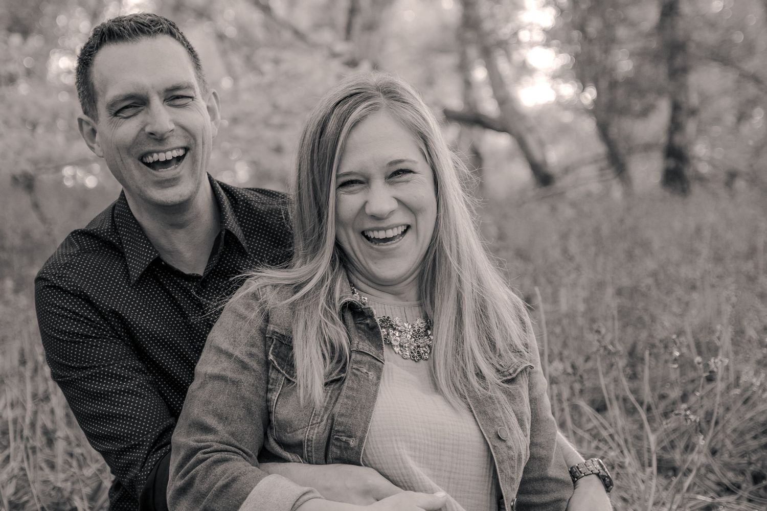 Husband and wife laughing.