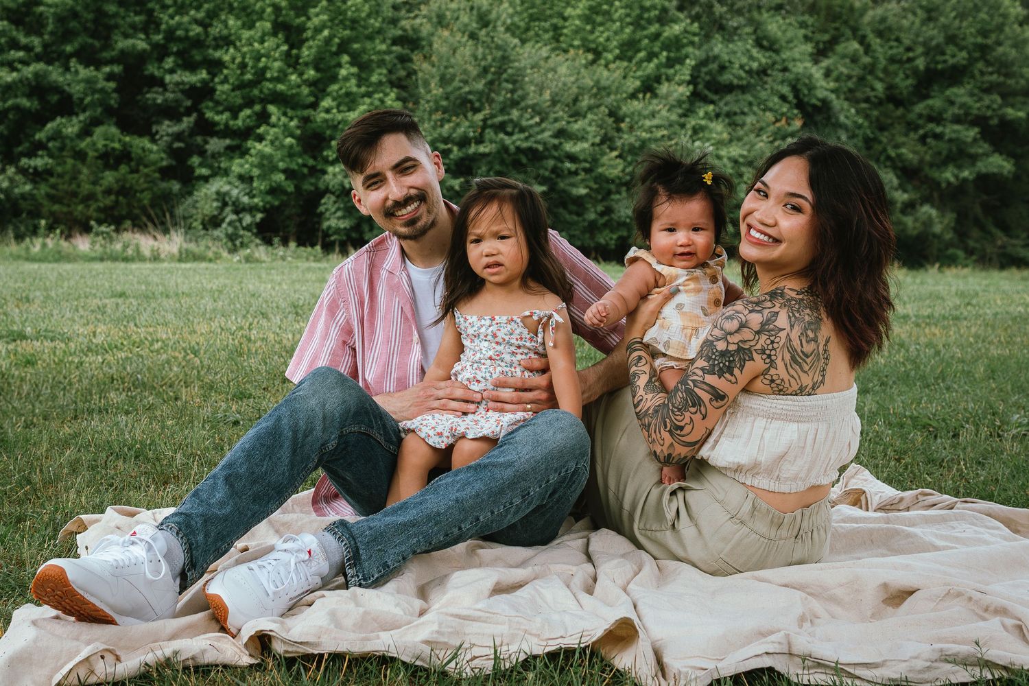 A sequence of casual outdoor family portrait shots on a grassy field with people relaxing on white blankets.